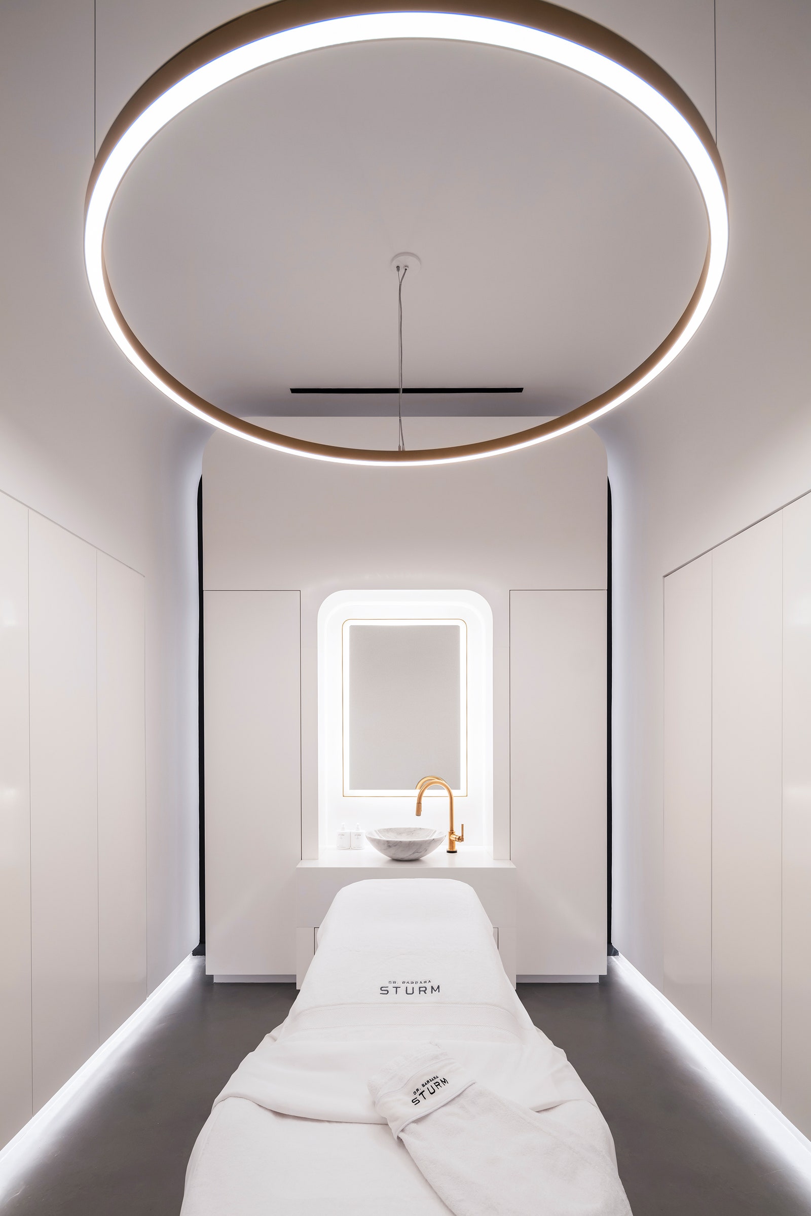 pA floating light fixture hangs over one of three treatment beds. p 